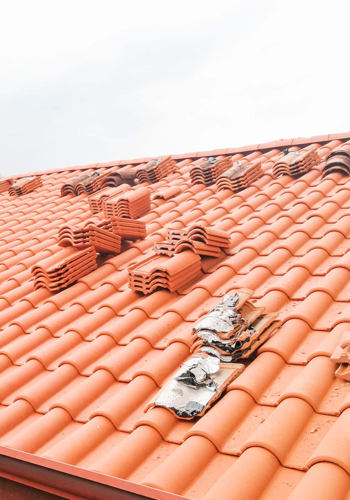 Old moldy roof tile being replaced with new tiles with nobody